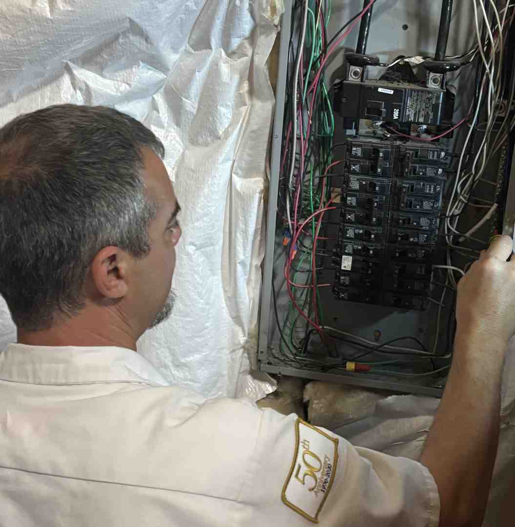 Close-up of an electrician's hands working on a circuit breaker panel - Electrical Panel Upgrade Close-up of an electrician's hands working on a circuit breaker panel - Electrical Panel Upgrade