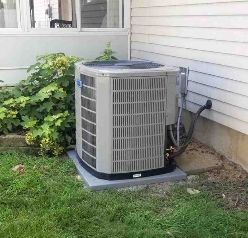American Standard heat pump unit outside a modern home - American Standard Heating & Cooling American Standard heat pump unit outside a modern home - American Standard Heating & Cooling