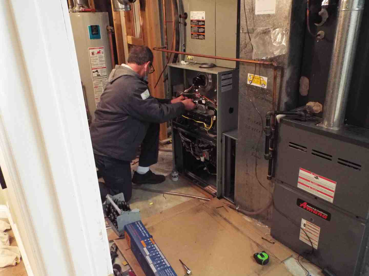 HVAC technician performing comprehensive maintenance check - ac maintenance company HVAC technician performing comprehensive maintenance check - ac maintenance company