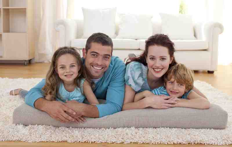 A smiling family enjoying their time together in a bright, well-maintained home living room, signifying comfort and peace of mind. - AAA Water Repair A smiling family enjoying their time together in a bright, well-maintained home living room, signifying comfort and peace of mind. - AAA Water Repair